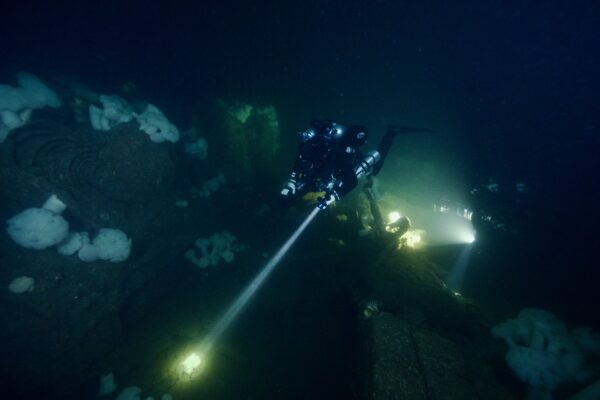 Divers swim past the intact water-tube boilers on the Admiral Knight wreck site (Photo: Conor Collins 2022).